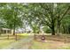 Expansive front yard and home exterior are surrounded by mature trees at 1145 Earl Rd, Shelby, NC 28152