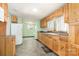 This kitchen has warm wood cabinetry, tile floors, and a sunny window for natural light at 1145 Earl Rd, Shelby, NC 28152