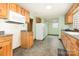 Spacious kitchen featuring natural light, a white refrigerator, tile floors, and wooden cabinets at 1145 Earl Rd, Shelby, NC 28152