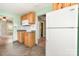 Kitchen view with tile floors, wooden cabinets, and a white refrigerator and microwave at 1145 Earl Rd, Shelby, NC 28152