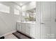 Bathroom featuring double sink vanity, a large mirror, and tile flooring at 125 White Apple Way, Statesville, NC 28625
