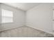 A bedroom featuring carpeted floors, a large window, and neutral walls at 125 White Apple Way, Statesville, NC 28625