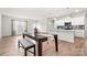 Open dining area with modern lighting adjacent to a modern kitchen with white cabinets at 125 White Apple Way, Statesville, NC 28625