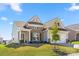 Attractive home featuring brick and siding accents, a covered entry, a well-kept lawn, and professional landscaping at 125 White Apple Way, Statesville, NC 28625