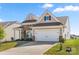 Beautiful home with a large driveway, two-car garage, neutral siding, brick accents, and a well-maintained lawn at 125 White Apple Way, Statesville, NC 28625