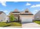 Charming two-story home with a two car garage, brick and siding exterior, landscaped yard, and inviting curb appeal at 125 White Apple Way, Statesville, NC 28625