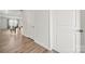 Bright hallway with wood floors and white doors providing access to different areas of the home at 125 White Apple Way, Statesville, NC 28625