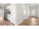 Hallway featuring wood floors, white trim, and a view of the home's entryway at 125 White Apple Way, Statesville, NC 28625