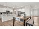 Open concept kitchen and dining area with white cabinets, stainless steel appliances and wood floors at 125 White Apple Way, Statesville, NC 28625