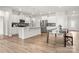 Open concept kitchen and dining area with white cabinets, stainless steel appliances and wood floors at 125 White Apple Way, Statesville, NC 28625