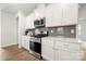 The kitchen has white cabinets, subway tile backsplash, and stainless steel appliances at 125 White Apple Way, Statesville, NC 28625