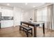 Open dining area with modern lighting adjacent to a modern kitchen with white cabinets at 125 White Apple Way, Statesville, NC 28625