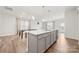 Bright kitchen features a large island with quartz countertops and stainless steel appliances at 125 White Apple Way, Statesville, NC 28625