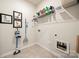 A laundry room featuring a vacuum, shelving, and shoe art at 125 White Apple Way, Statesville, NC 28625