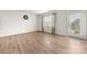 Open living room with wood floors and natural light from a window and doorway at 125 White Apple Way, Statesville, NC 28625