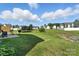 This wide backyard features ample green space, a trampoline, a concrete patio, and suburban home views at 12522 Palomino Dr, Midland, NC 28107