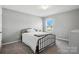 Clean bedroom features large window, light gray walls, and carpet flooring at 12522 Palomino Dr, Midland, NC 28107