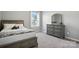 Cozy bedroom with carpet, light gray walls, and a large window for natural light at 12522 Palomino Dr, Midland, NC 28107