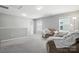 Inviting bonus room featuring neutral carpet, plentiful natural light, and comfortable seating space at 12522 Palomino Dr, Midland, NC 28107