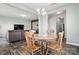 Cozy dining area adjacent to the living room, featuring a wooden table set and modern chandelier lighting at 12522 Palomino Dr, Midland, NC 28107