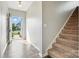 Bright entryway featuring hardwood floors, a staircase, and an open view to the outdoors at 12522 Palomino Dr, Midland, NC 28107