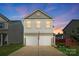 Charming two-story home with a two-car garage and an American flag waving in front at 12522 Palomino Dr, Midland, NC 28107