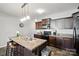 Spacious kitchen island, dark cabinetry, and a breakfast bar with seating at 12522 Palomino Dr, Midland, NC 28107