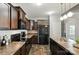 Well-equipped kitchen featuring black appliances, dark cabinets, and ample counter space at 12522 Palomino Dr, Midland, NC 28107