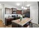 Stylish kitchen featuring an island, dark cabinets, modern appliances, and a cozy breakfast bar at 12522 Palomino Dr, Midland, NC 28107