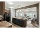 Modern kitchen with an island, dark cabinets, and an open view to the living area at 12522 Palomino Dr, Midland, NC 28107