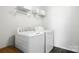 Bright laundry room with modern washer and dryer, and storage shelves at 12522 Palomino Dr, Midland, NC 28107