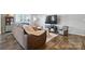 Inviting living room featuring a comfortable brown sofa, modern decor, and stylish dark wood-look flooring at 12522 Palomino Dr, Midland, NC 28107