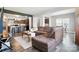 Open-concept living room with a cozy brown sectional sofa, seamlessly connected to the kitchen and dining area at 12522 Palomino Dr, Midland, NC 28107