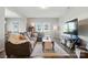 Cozy living room with hardwood floors, a comfortable sofa, and a large television at 12522 Palomino Dr, Midland, NC 28107