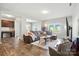 Bright living room featuring hardwood floors, a comfortable sofa, and an open layout at 12522 Palomino Dr, Midland, NC 28107