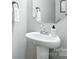 Modern powder room featuring a sleek pedestal sink, contemporary faucet, and minimalist decor at 12522 Palomino Dr, Midland, NC 28107