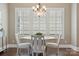 Bright dining room with white table, chairs, chandelier, and large windows providing ample natural light at 12525 Druids Glen Dr, Pineville, NC 28134