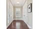 Bright foyer with hardwood floors, a window for natural light, and convenient closet space at 12525 Druids Glen Dr, Pineville, NC 28134