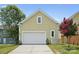 Spacious detached garage with a white door, set against a backdrop of a well-maintained yard at 12525 Druids Glen Dr, Pineville, NC 28134