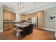 Well-equipped kitchen with stainless steel appliances, wooden cabinets, and an island with seating at 12525 Druids Glen Dr, Pineville, NC 28134