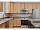 Kitchen featuring granite countertops, stainless steel appliances, tile backsplash and plenty of cabinet space at 12525 Druids Glen Dr, Pineville, NC 28134