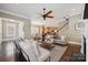 Open concept living space with a ceiling fan, visible staircase, and seamless transition to the kitchen at 12525 Druids Glen Dr, Pineville, NC 28134