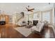 Inviting living room with hardwood floors, a fireplace, and neutral decor for a cozy atmosphere at 12525 Druids Glen Dr, Pineville, NC 28134