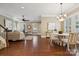 Open floor plan with the living room, dining area, and staircase creates an inviting and airy atmosphere at 12525 Druids Glen Dr, Pineville, NC 28134