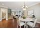 Open concept living and dining area, perfect for entertaining, features a seamless flow and hardwood floors at 12525 Druids Glen Dr, Pineville, NC 28134