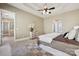 Large main bedroom with tray ceiling, ceiling fan, carpet, and lots of natural light from the windows at 12525 Druids Glen Dr, Pineville, NC 28134