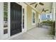 Inviting front porch featuring stylish seating, a ceiling fan, and a welcoming entrance at 12525 Druids Glen Dr, Pineville, NC 28134