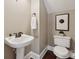 Small powder room with pedestal sink, framed art, and tile flooring at 12525 Druids Glen Dr, Pineville, NC 28134