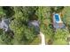 Aerial view of a brick home with pool, driveway, mature trees, and green grass at 1587 Summit View Dr, Rock Hill, SC 29732