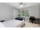 Cozy bedroom with a metal frame bed and an office setup by the window at 1587 Summit View Dr, Rock Hill, SC 29732